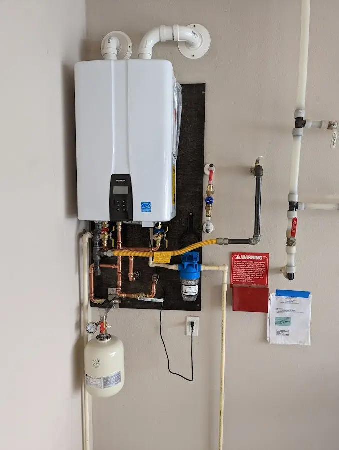 Professional plumber installing copper piping in a Cresaptown home